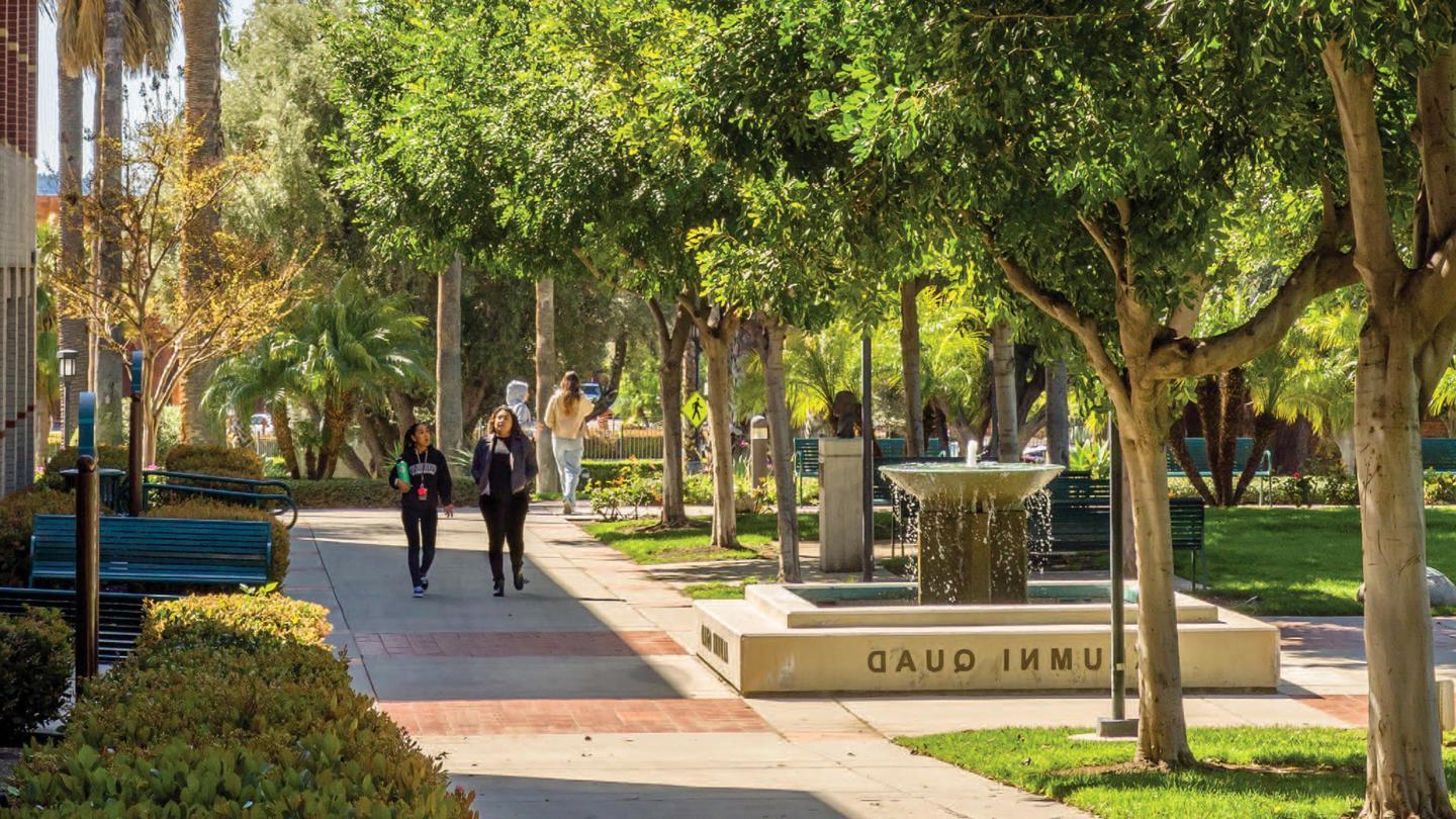 Two students walking and talking across the Woodbury Campus in Burbank.